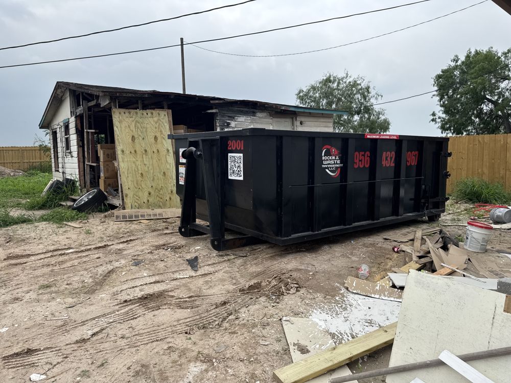 Black Rockin JL dumpster next to a shed tear down